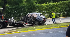 After being hit by a car running a red light, this car crashed through the fence of a nearby apartment complex in Kendall. (Andre Andrade/SFMN)