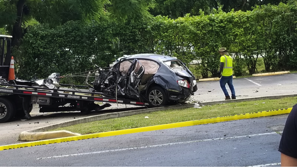 After being hit by a car running a red light, this car crashed through the fence of a nearby apartment complex in Kendall. (Andre Andrade/SFMN)